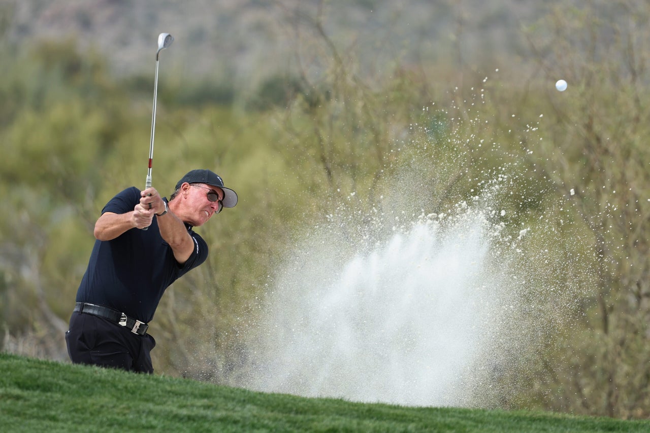 Phil Mickelson hitting a wedge from a bunker