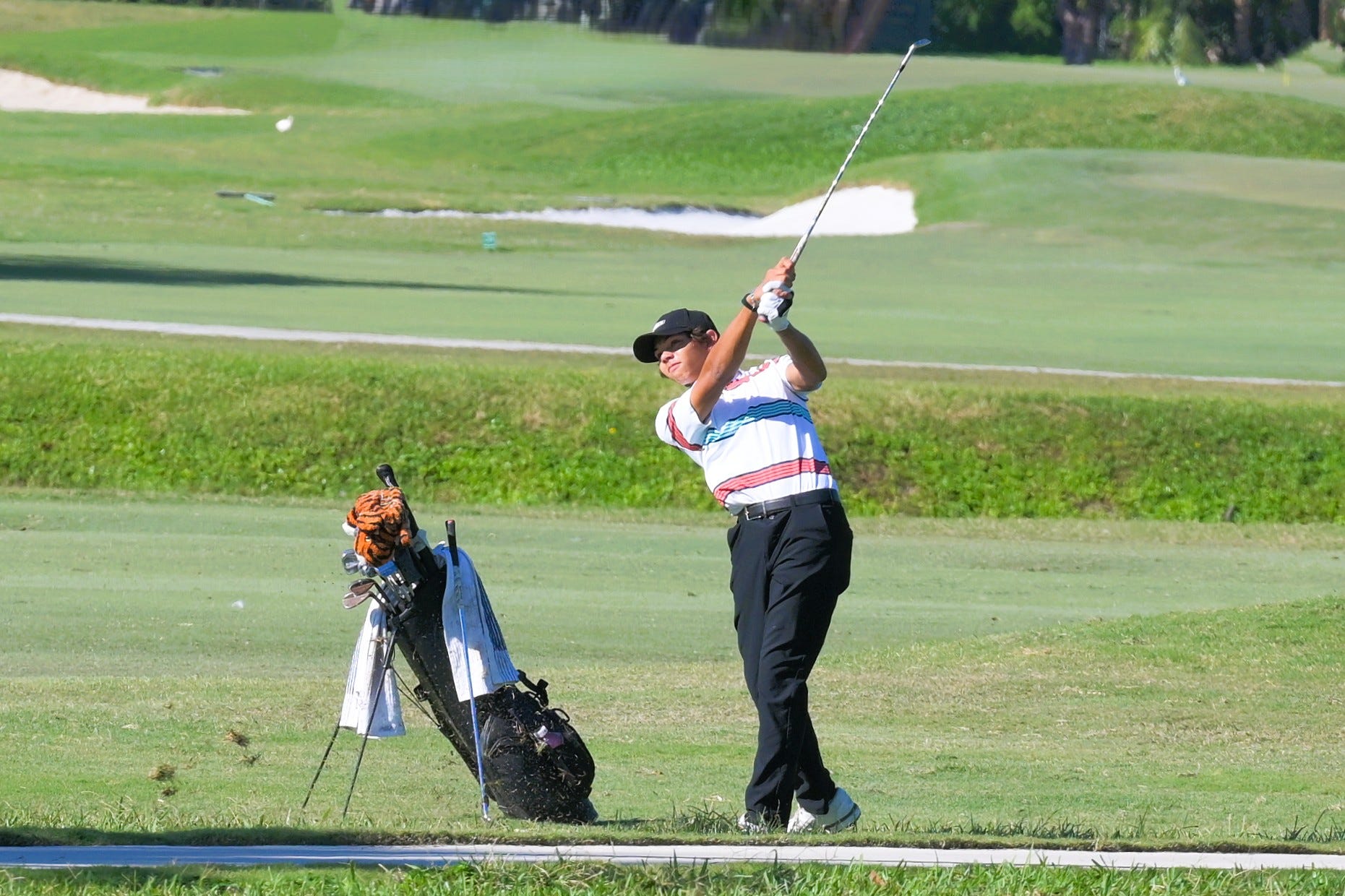 Charlie Woods shots from the fairway while on Hole 6