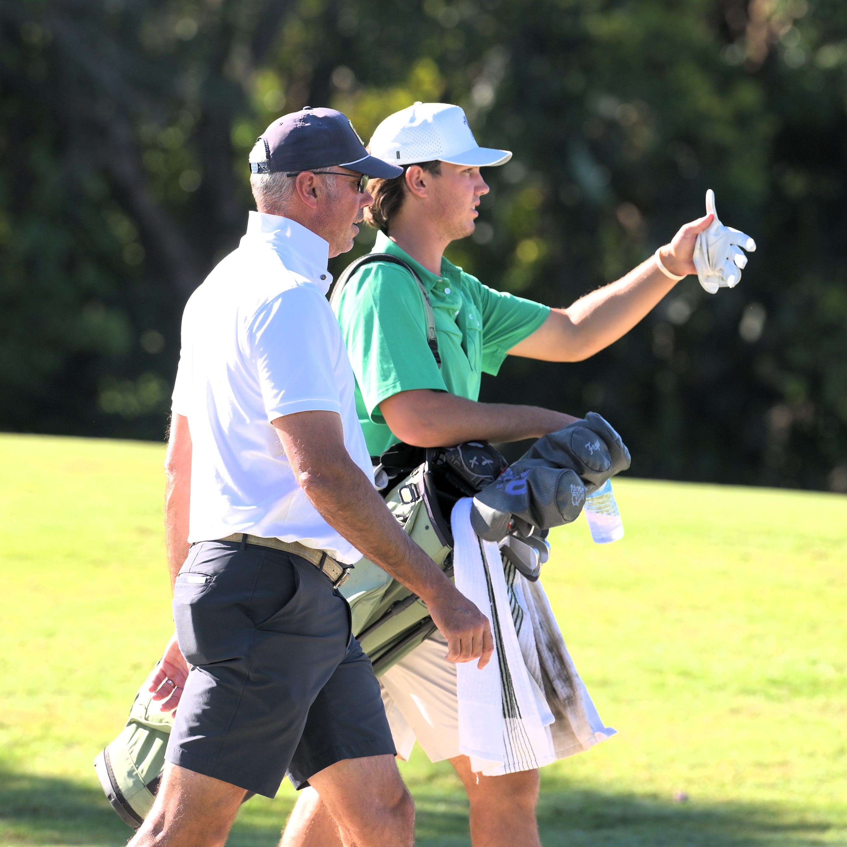 Matt Kuchar discussing strategy with son Cameron Kuchar